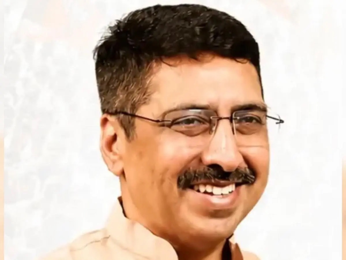 Close portrait of Deepak Mhaskey, smiling, wearing rimless spectacles and a light kurta.