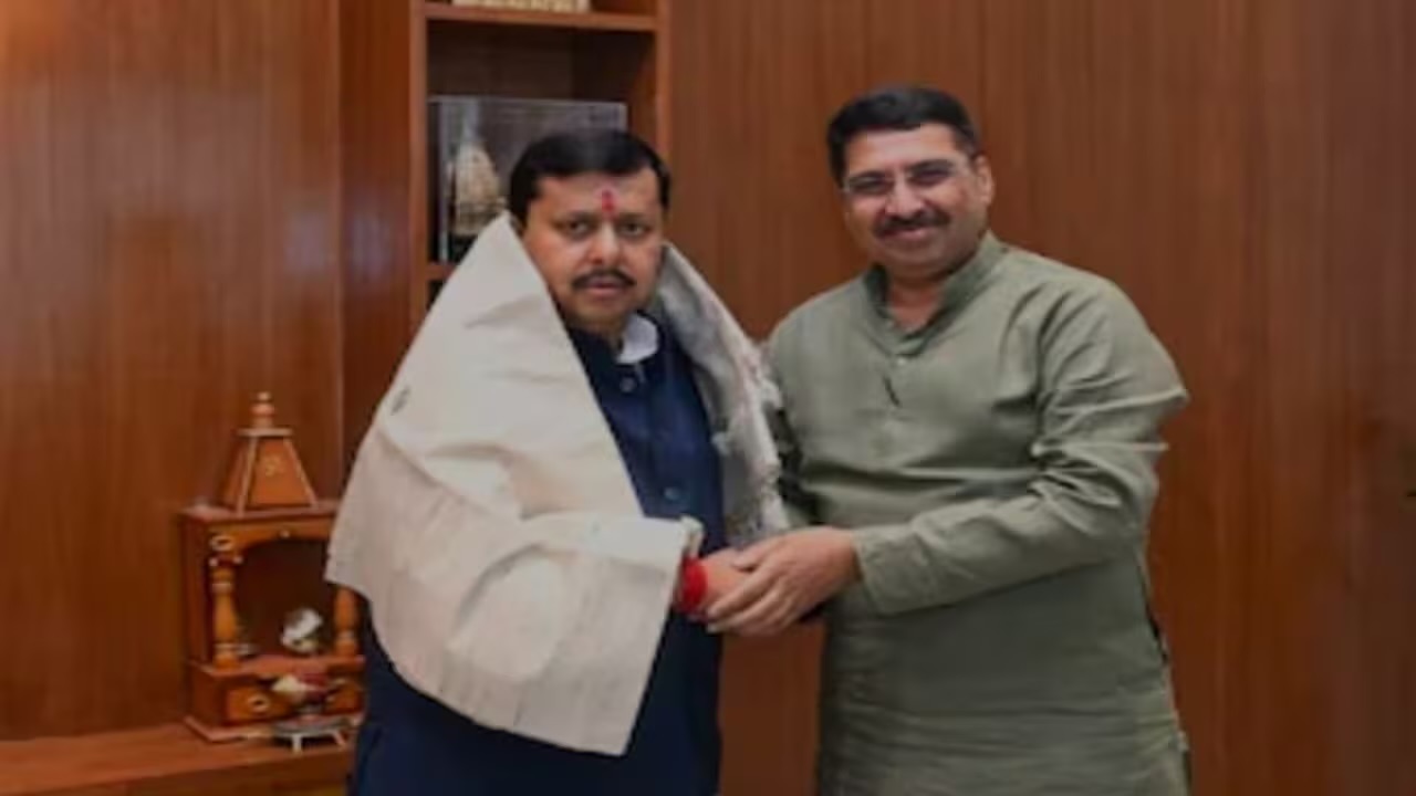 Deepak Mhaskey standing with a senior party leader who is wearing a ceremonial shawl, at a meeting marking his national appointment.
